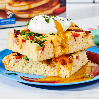 https://www.krusteaz.com/wp-content/uploads/2022/11/Savory-Sheet-Pancakes-with-Poached-Eggs-and-Melted-Queso-with-Cilantro-Garnish.jpg