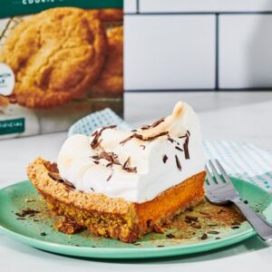 A slice of Snickerdoodle Crust Pumpkin Pie topped with marshmallow meringue and cracked chocolate.