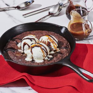 Brownie made in a skillet served with ice cream