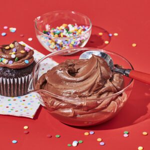 Chocolate buttercream frosting in a glass bowl