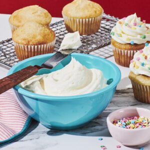 Vanilla buttercream frosting in a blue bowl