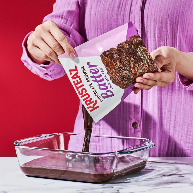 Krusteaz Chocolate Brownie batter being poured into a pan