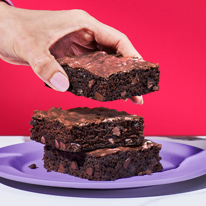 A hand grabbing a brownie