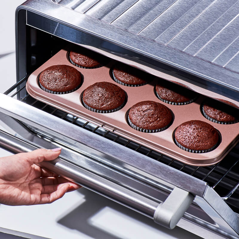 Placing cupcakes into an oven