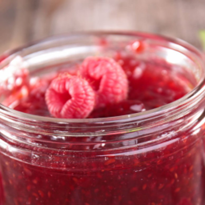 Raspberry jam in a glass container